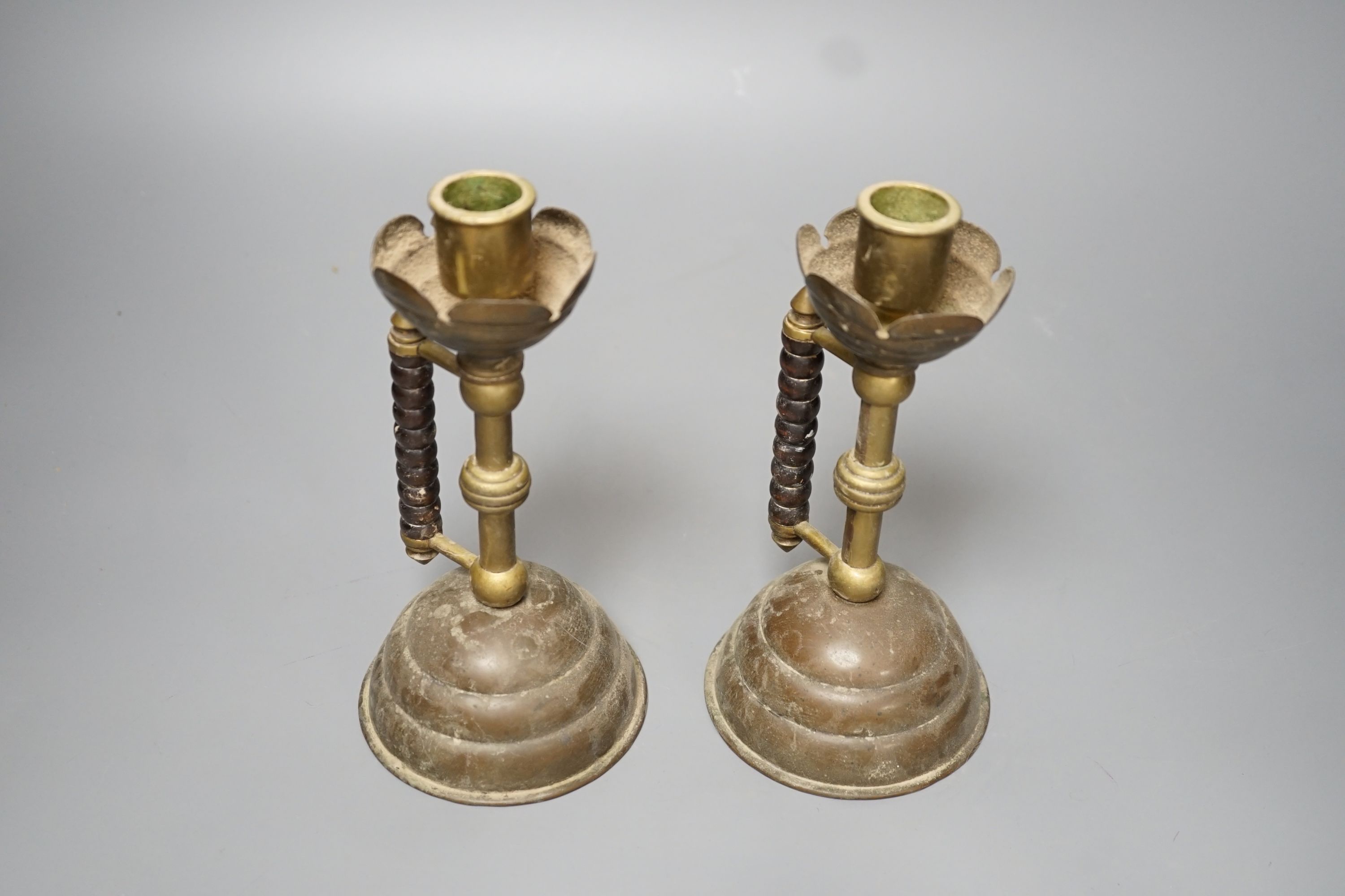 A pair of Gothic brass stem cup and handled candlesticks - 19.5cm high